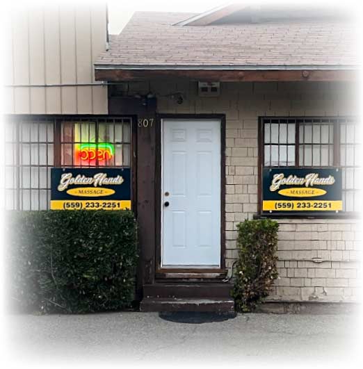 Exterior storefront of Golden Hands Massage located at 807 E Hedges Ave in Fresno CA, featuring open neon signs and private entrance for professional massage therapy.